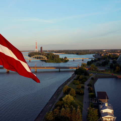 videoblocks-huge-latvian-flag-flutters-on-wind-with-riga-old-town-in-the-background-in-latvia-patriotic-video_holtc11xw_thumbnail-1080_01